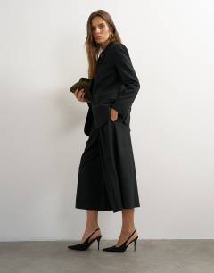 Model wearing Belted pleated cropped wide leg trouser in black