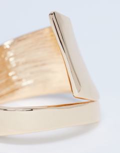 Model wearing Bethany plated bangle in gold