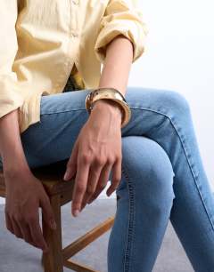 Model wearing Bianca chunky twisted bracelet in gold