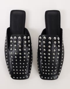 Model wearing Bianca studded flat shoe in black