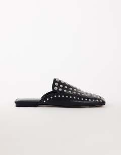 Model wearing Bianca studded flat shoe in black