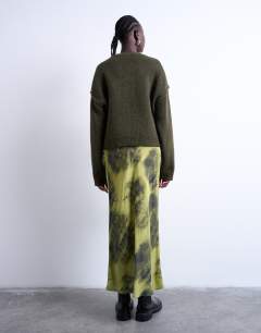 Model wearing Bias maxi skirt with blurred floral print in green