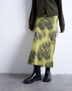 Model wearing Bias maxi skirt with blurred floral print in green