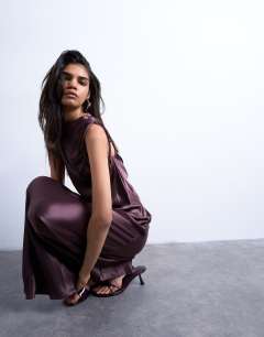 Model wearing Bias ruched arm hole maxi occasion dress in deep burgundy