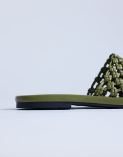 Model wearing Bibi woven mule in olive