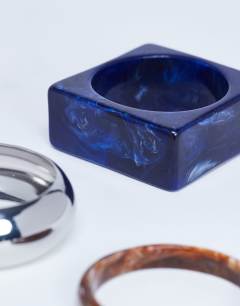 Model wearing Blanks 3 pack bangles in wood, silver & blue