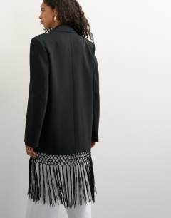 Model wearing Blazer with fringe detail in black