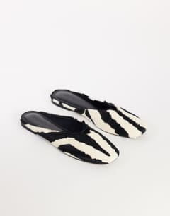 Model wearing Blythe knotted flat mule in zebra print hair on real leather
