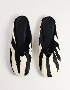 Model wearing Blythe knotted flat mule in zebra print hair on real leather
