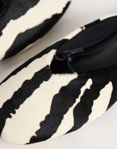 Model wearing Blythe knotted flat mule in zebra print hair on real leather
