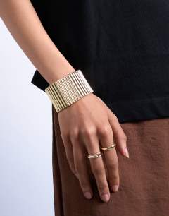 Model wearing Bobbi bangle in gold