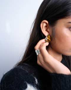 Model wearing Bobbi triangular stud pearl earrings in silver