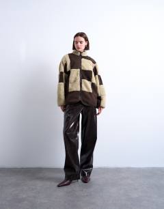 Model wearing Borg checkerboard fleece with quilted lining jacket in brown and cream