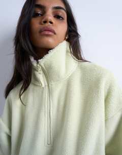 Model wearing Borg fleece funnel quarter zip co-ord in lime green