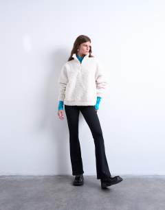 Model wearing Borg quarter zip top in ecru