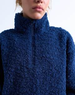 Model wearing Borg quarter zip top in navy