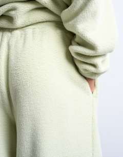 Model wearing Borg straight leg joggers co-ord in lime green