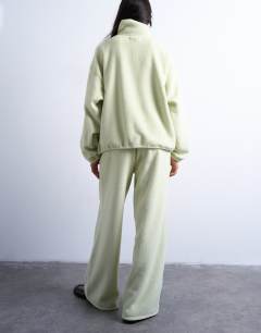 Model wearing Borg straight leg joggers co-ord in lime green