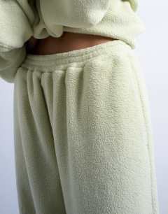 Model wearing Borg straight leg joggers co-ord in lime green