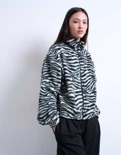 Model wearing Borg zebra print zip through fleece in monochrome