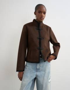 Model wearing Boucle short mandarin jacket with frogging in chocolate
