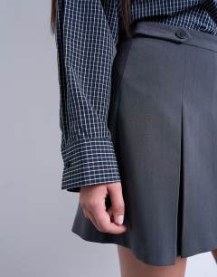 Model wearing Box pleat grey mini skirt