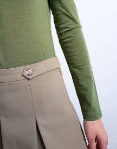 Model wearing Box pleat taupe mini skirt