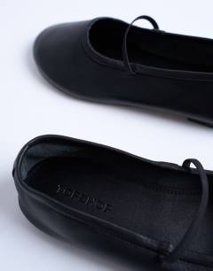 Model wearing Brad leather ballerina with elastic strap in black
