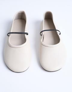 Model wearing Brad leather ballerina with elastic strap in off white