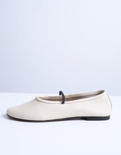 Model wearing Brad leather ballerina with elastic strap in off white