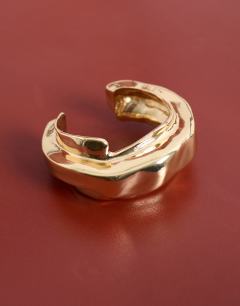 Model wearing Brena asymmetric bangle in gold