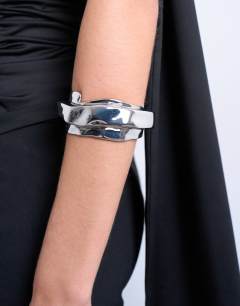 Model wearing Brena asymmetric bangle in silver