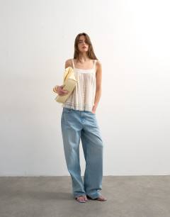 Model wearing Broderie and lace top in white
