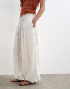 Model wearing Broderie beach balloon trouser in white