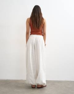 Model wearing Broderie beach balloon trouser in white
