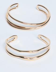 Model wearing Brooklyn 2 pack cuff bracelets in gold tone