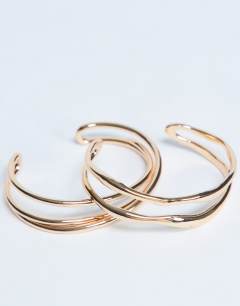 Model wearing Brooklyn 2 pack cuff bracelets in gold tone