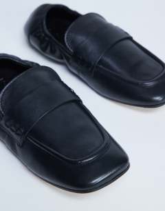 Model wearing Brooks ruched back real leather flat shoe in black