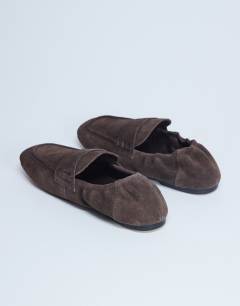 Model wearing Brooks ruched back real suede leather flat shoe in chocolate