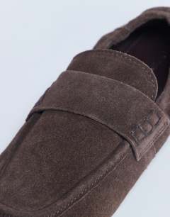 Model wearing Brooks ruched back real suede leather flat shoe in chocolate