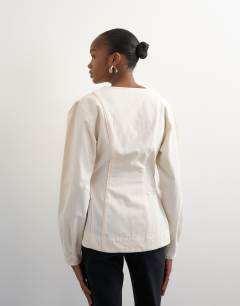 Model wearing Brushed cotton cocoon sleeve structured button through top in ecru