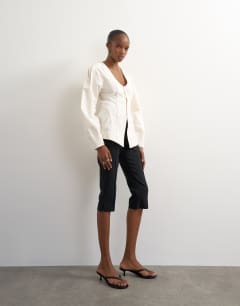 Model wearing Brushed cotton cocoon sleeve structured button through top in ecru