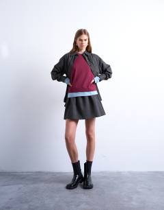 Model wearing Brushed low rise flippy mini micro skirt in charcoal pinstripe