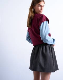 Model wearing Brushed low rise flippy mini micro skirt in charcoal pinstripe