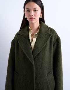 Model wearing Brushed unlined dropped shoulder clean chuck on coat with wool in khaki