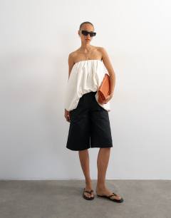 Model wearing Bubble hem high low bandeau in ecru