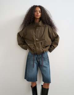 Model wearing Bubble hem mac in check