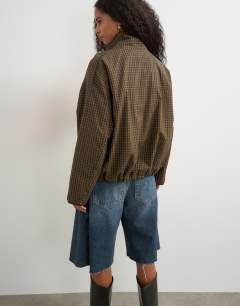 Model wearing Bubble hem mac in check