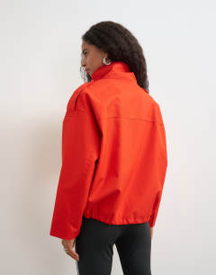 Model wearing Bubble hem mac in red