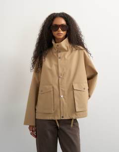 Model wearing Bubble hem trench in stone